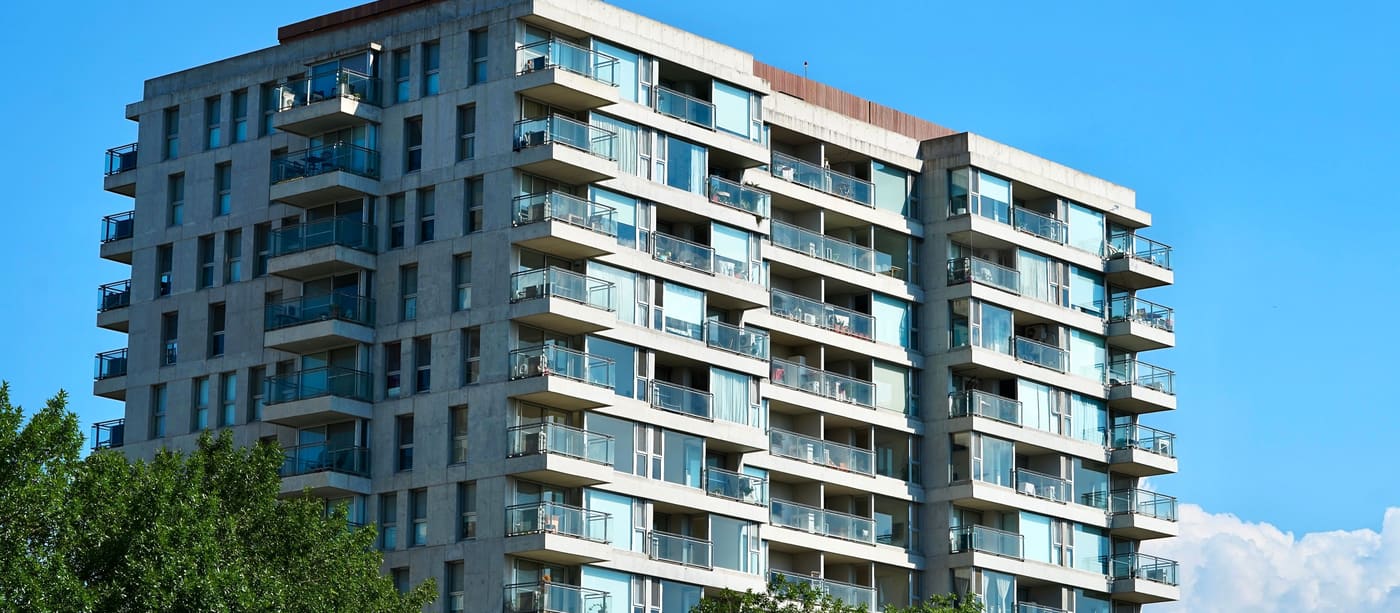 The facade of a contemporary Argentine apartment building, balconies stacked floor by floor.