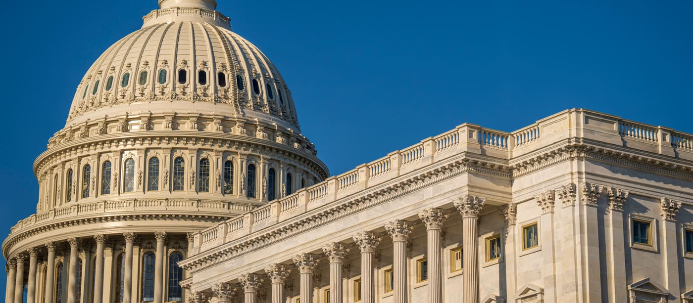 The dome of the United States Capitol against a clear sky.